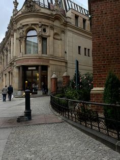 people are walking around in front of a building