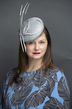 Luminous metallic silver sinamay straw button fascinator. Trimmed in metallic silver hemp straw braid and white tipped, floating, metallic silver arrow feathers. Light and easy to wear Features a comb and elastic attachment for comfortable all day wear. Lifted Millinery headwear is constructed with time honored techniques and fine craftsmanship. All hats are meticulously blocked and sewn by hand without the use of adhesives to attach trims. This ensures a long lasting hat with the ability to be Silver Fascinator Hat For Formal Occasions, Silver Formal Fascinator Hat, Silver Formal Hat Fascinator, Silver Adjustable Headpiece For Kentucky Derby, Adjustable Silver Fascinator For Spring, Spring Silver Adjustable Fascinator, Arrow Feather, Silver Arrow, White Tip