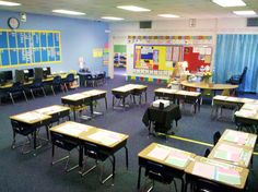 an empty classroom with desks and chairs