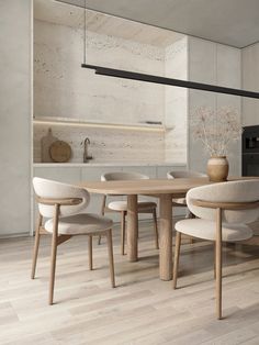 a dining room table with chairs and a potted plant