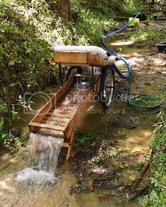 a bike with a water hose attached to it is in the middle of a stream