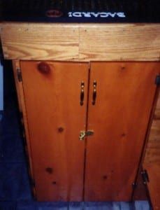 an old wooden cabinet with a black top