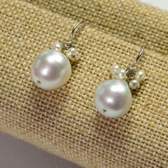 DESCRIPTION: Thank you for coming in! 14K solid white gold earrings with 11mm South Sea white baroque pearls and seed pearl accents! Full of luster and elegance! ! It looks much much nicer on your ears! You will receive the exact pair of earrings in the pictures! WEIGHT: 4.63 Grams LENGTH: 1 inch MATERIAL: 14K Solid White Gold, South Sea White Pearl, Seed Pearls White Sterling Silver Cluster Earrings For Formal Occasions, Formal White Sterling Silver Cluster Earrings, Luxury White Sterling Silver Cluster Earrings, White Round Bead Pearl Earrings For Formal Occasions, Formal White Pearl Round Bead Earrings, Classic White Pearl Earrings With Lever Back, White Sterling Silver Drop Cluster Earrings, Elegant Silver Briolette Pearl Earrings, White Pearl Pendant Earrings For Anniversary