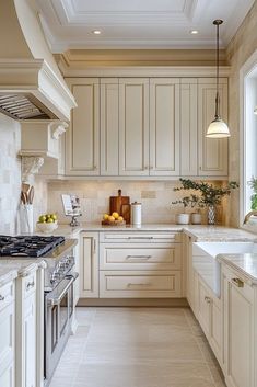 a kitchen filled with lots of white cabinets and counter tops