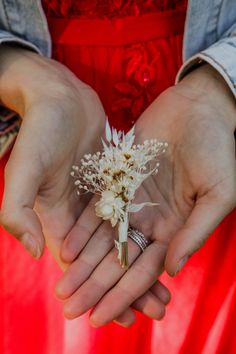 a person holding flowers in their hands