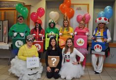 group of people dressed up in costumes posing for the camera