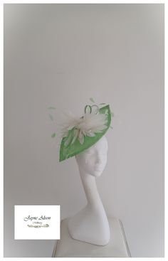 Striking oversized petal in apple green sinamay, which gently curves and sweeps creating height and width with elegance.   A sinamay bow is  encased with an abundance of delicate contrasting shades of ivory goose  feathers, with delicate, contrasting  coq feather tips, which dance in the breeze. .   A truly femenine piece with classic elegance. Sits on a headband.  'This item has sold, however, similar pieces can be made in a variety of colours.  Please ask for details.  As every piece is handma Ivory Fascinator, Fascinator Wedding, Wedding Hat, Kentucky Derby Hat, Goose Feathers, Derby Hat, Royal Ascot, Wedding Hats, Derby Hats