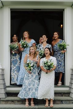 a group of women standing on top of a set of steps next to each other