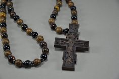 Orthodox Beads Necklace in religious style with the use of , wenge wood, agate, Tiger's Eye, hematite.  The Christian cross is made of pear wood on a milling machine and finished by hand. You will receive a strong religious amulet that combines the power of wood, stones and your faith. Size: 27 inches If you need a different size, please email me. All items from this shop are handmade and done with love. ♥ ♥ ♥ Brown Crucifix Necklace In Spiritual Style, Spiritual Brown Crucifix Necklace, Spiritual Brown Cross Necklace, Wooden Cross Necklace, Wooden Man, Wenge Wood, Pear Wood, Christian Necklace, Necklace Men