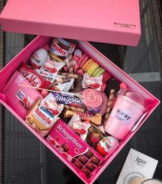 a pink box filled with lots of different types of candies