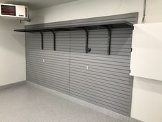 an empty storage room with no one in the room or there is a air conditioner on the wall