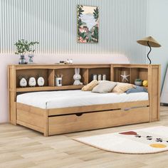 a bed with drawers underneath it in a room