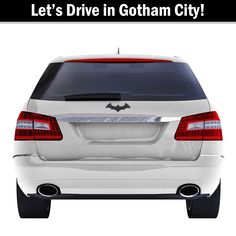 the back end of a white car with black lettering on it that says, let's drive in gotham city