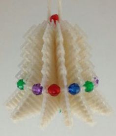 an ornament shaped like a christmas tree with candy on it's sides