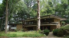 the house is surrounded by trees and grass