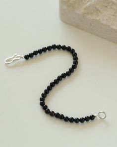 Add a touch of sophistication to your wrist with our Black Onyx Beaded Bracelet—a sleek and versatile accessory that seamlessly blends the timeless beauty of black onyx beads with a minimalist design. Metal: Recycled Sterling Silver Gemstone: Black Onyx 4mm Length: 170mm Weight: 5g Elegant Black Bracelets For Everyday, Minimalist Black Beaded Bracelets, Minimalist Onyx Beaded Bracelets With Round Beads, Minimalist Black Onyx Beaded Bracelets, Minimalist Onyx Beaded Bracelet With Round Beads, Minimalist Single Strand Beaded Bracelets With Round Beads, Everyday Black Beaded Bracelets With Round Beads, Minimalist Onyx Beaded Bracelet, Minimalist Single Strand Beaded Bracelet