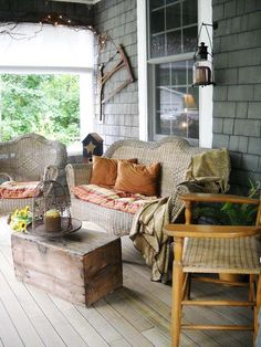 the porch is decorated with wicker furniture