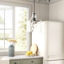 a white refrigerator freezer sitting inside of a kitchen next to a sink and window