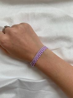 This bracelet set is made of pastel purple thread. The bracelets are perfect for a cute minimalist look while still having a sophisticated and preppy look. They really fit in with the outer banks style which is so trendy at the moment! It can be styled with so many pieces to make any outfit really cute and trendy. There are 3 bracelets in this set that can be worn separately or together.  This vsco style is so popular at the moment and this bracelet is the perfect fit for that! Something that ki Casual Purple Friendship Bracelets, Kiara Outer Banks Style Bracelets, Trendy Purple Braided Bracelet Gift, Trendy Purple Braided Bracelet For Gift, Casual Purple Bracelet For Everyday, Casual Everyday Purple Bracelets, Trendy Purple Friendship Bracelets, Casual Purple Friendship Bracelets For Beach, Casual Purple Braided Bracelets For Beach