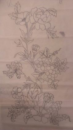 a drawing of flowers and leaves on a piece of white paper with black ink in it