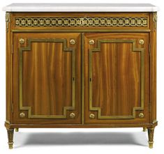 an antique wooden cabinet with marble top