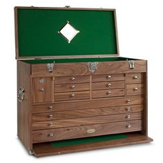 an old chest with many drawers and green leather lining on the top, in front of a white background