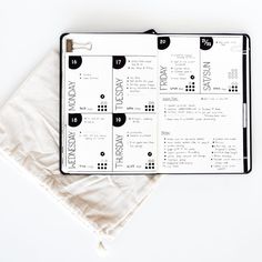 an open planner sitting on top of a white table