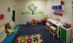 a child's playroom with toys and desks in it, including a bed