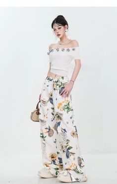 Elevate your style with our Breezy Bloom Embroidered Wide-Leg Jeans. These high-quality denim pants feature delicate floral embroidery, a relaxed wide-leg fit, and trendy distressed details. The high waist flatters and elongates, while multiple pockets add functionality. Versatile and easy to care for, these jeans effortlessly pair with various tops for chic, bohemian-inspired looks. Model Information: Size - S, Height - 165 cm, Weight - 45 kg, Bust/Waist/Hip - 80/59/85 cm Casual Straight Leg Bottoms With Floral Embroidery, Floral Print Cotton Pants For Day Out, High Waist Floral Embroidered Jeans For Summer, Straight Leg Floral Print Bottoms For Vacation, Casual Relaxed Fit Floral Print Bottoms, Vacation Bottoms With Floral Print And Straight Leg, Floral Print Straight Leg Bottoms For Vacation, Vacation Floral Print Cotton Bottoms, Casual Cotton Bottoms With Floral Embroidery