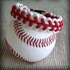 a white baseball with red stitching on it's headbands sitting on a table