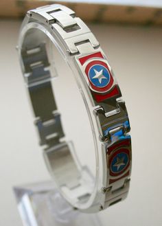 the captain's shield bracelet is made from metal and has red, white, and blue accents