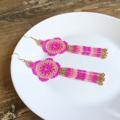 Add brightness and floral vibe to your everyday look with the help of these hot pink beaded earrings. These huichol flower earrings inspired by Mexican style. These statement mandala earrings are made from high-quality Czech seed beads and stainless steel accessories. No doubts, these fuschia seed bead earrings become a bright detail of any look and a unique gift for anybody who loves artisan jewelry in tribal style. 100% top quality handmade earrings. Length: 4.72'' / 12 cm Flower diameter: 1.42'' / 3,6 cm Fringe length: 2.17'' / 5,5 cm Materials:  - Czech seed beads - stainless steel accessories. The real color of the item may be slightly different from the picture shown on website caused by the brightness of your monitor. If you have special size requirements, please send me a letter ab Beaded Fuschia Flower Earrings, Mexican Mandala, Flower Beaded Earrings, Pink Beaded Earrings, Mandala Earrings, Steel Accessories, Stainless Steel Accessories, Mexican Style, Seed Bead Earrings