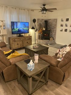 a living room filled with furniture and a flat screen tv mounted on the wall above a fireplace