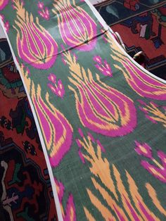 two colorful rugs laying on top of each other