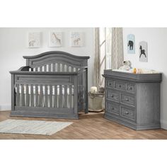 a baby crib and dresser in a room