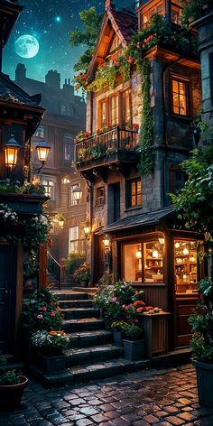 an image of a city street at night with lights and flowers on the steps leading up to it