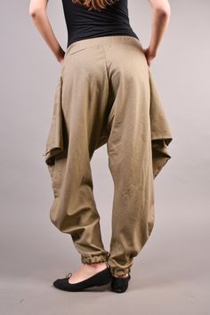 "Linen Harem Pants, Harem Trousers, Baggy Pants, Loose Pants. Extravagant harem trousers with interesting and unusual cut. The baggy pants are loose fit and feature drop crotch. The model is made of linen fabric so it is extremely comfortable women pants suitable for the daytime. If you are looking for the perfect addition to your casual outfit these loose pants are a great choice matched with flats or sneakers. ^ Sizes: The item can be made in sizes from XXS to 7XL. Please, use the size chart b Khaki Wide-leg Harem Pants Loosely Fitted Hips, Khaki Harem Pants With Loosely Fitted Hips, Beige Baggy Wide-leg Harem Pants, Beige Wide-leg Harem Pants, Khaki Wide Leg Harem Pants With Loose Fit, Casual Beige Harem Bottoms, Beige Baggy Wide Leg Harem Pants, Beige Wide Leg Harem Pants, Baggy Beige Bottoms With Hip Pockets