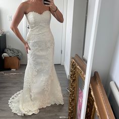 a woman taking a selfie in her wedding dress