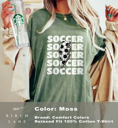 Calling all soccer lovers....get ready for soccer season with this adorable soccer tshirt! Looking for a different Soccer design? We have several to choose from in our shop, simply use the link below: https://www.etsy.com/shop/OnBirchLane?ref=seller-platform-mcnav&search_query=soccer This cozy tee features a soccer ball print lightning graphic with the repeating words soccer, on a comfortable fit, crewneck tshirt that fits like a well-loved favorite.  Soft cotton and quality print make this fun game day tee one that you will fall in love with it over and over again. More on comfort and fit: ------------------- This cozy t-shirt is garment-dyed t-shirt made 100% with ring-spun cotton. The soft-washed, garment-dyed fabric brings extra coziness to your wardrobe while the relaxed fit makes it Green T-shirt With Letter Print For Football Season, Green T-shirt With Sublimation Print For Football Season, Casual Green Sublimation T-shirt With Team Name, Green Football Season Sports Fan T-shirt, Green Sports Fan T-shirt For Football Season, Green Letter Print Tops For Football Season, Green Pre-shrunk T-shirt For Football Season, Pre-shrunk Green T-shirt For Football Season, Soccer Tshirt Outfit