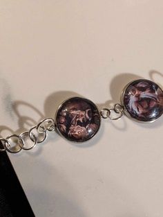 two bracelets that have pictures on them