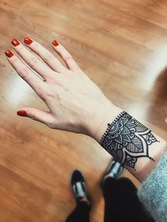 a woman's hand with a tattoo on it