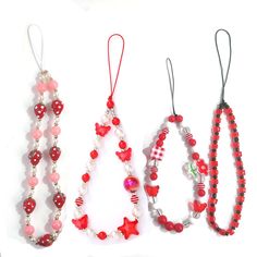 three necklaces with beads and hearts on them are lined up against a white background