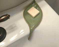 a bathroom sink with a faucet and soap dispenser on it