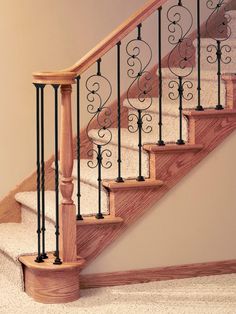 a staircase with wrought iron railing and handrail