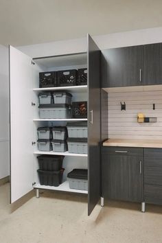 an empty kitchen with lots of storage and bins on the shelves next to it