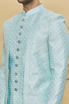 Sky blue layered sherwani with embroidered motifs and patch pocket. Paired with aligarhi pant.
Component: 2
Pattern: Embroidered
Type Of Work: Floral
Neckline: Mandarin
Sleeve Type: Full Sleeves
Fabric: Art Silk, Dupion Art Silk
Color: Blue
Other Details: 
Front button placket
Note: Pocket square worn by the model is not for sale
Occasion: Wedding - Aza Fashions Blue Floral Art, Embroidered Sherwani, Embroidered Motifs, Full Sleeves, Blue Art, Embroidered Silk, Fabric Art, Pocket Square, Aza Fashion