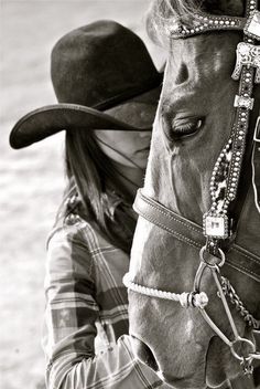 a black and white photo of a horse with a cowboy hat on it's head