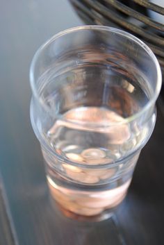 a clear glass filled with water sitting on top of a table