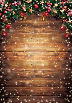 a wooden background with christmas decorations and stars on the top, along with snow flakes