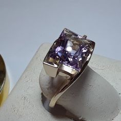 This Stunning Custom Italian Ring Features A 14x10mm Natural Radiant Cut Light Color Amethyst, Set With 4 Secure Prongs. The Bypass Design Gives The Appearance That The Amethyst Is Floating Between 2 Bars Of Solid High Polished Yellow Gold. The Ring Measures Aprox 9/16" In Width At The Center, And Weighs Aprox 8.266 Grams Of Solid (Stamped 14kt Italy & Manufacture) 14kt Yellow Gold. This Custom Italian Amethyst Ring Has A Msrp Of $8719.00. Finger Size 8 (This Ring Can Be Sized By Your Jeweler) Elegant Lavender Amethyst Ring In 14k Gold, Classic Amethyst Ring In Yellow Gold With Sterling Silver, Elegant 14k Gold Amethyst Ring With Polished Finish, Elegant Silver Amethyst Ring In 14k Gold, Elegant Amethyst Ring In 14k Gold Silver, Lavender 14k Gold Jewelry For Formal Occasions, Belly Button Piercing Rings, Italian Ring, Amethyst Cocktail Ring